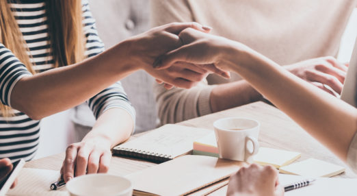 Close up image of two female hands shaking